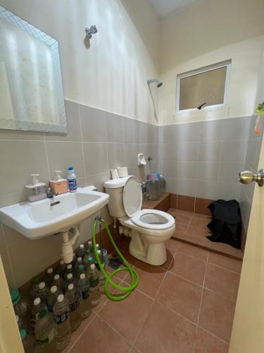 a bathroom with a toilet and a sink at Sandakan Homestay & Backpackers in Sandakan