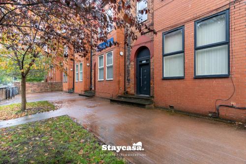 an empty street in front of a brick building at Casa Cove GF Flat Free Parking - 5min to Hospital in Manchester