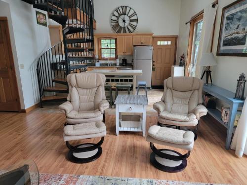 a living room with two chairs and a table at Wolfe's Way in Franklin