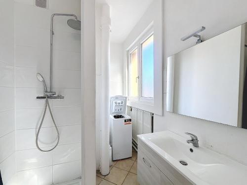 une salle de bain blanche avec une douche et un lavabo dans l'établissement Appartement Dunkerque hyper centre, à Dunkerque