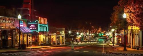 a city street at night with lit up buildings at Mariner's Reach in Sullivan