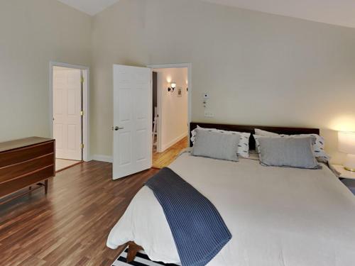 a bedroom with a large white bed and a dresser at Saco Sanctuary in Saco