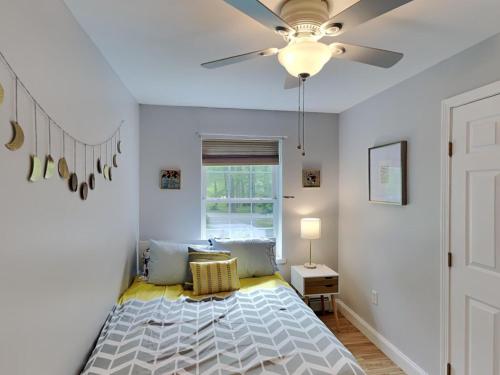 a bedroom with a bed with a ceiling fan at Saco Sanctuary in Saco