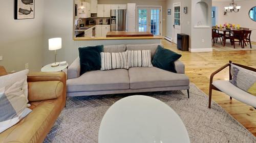 a living room with a couch and a kitchen at Saco Sanctuary in Saco