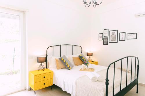 a bedroom with a bed and a yellow nightstand at Massaria Donna Oliva in Buccino