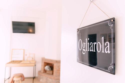 a sign hanging from a wall in a living room at Massaria Donna Oliva in Buccino
