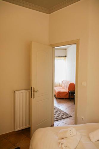 a bedroom with a bed and a door to a room at Guest House Ioanna Arachova in Arachova