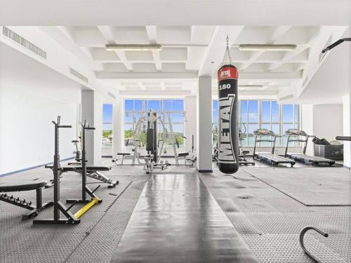 a gym with treadmills and machines in a room at Luxury Lagoon-View Condo Steps to Beach in Cupecoy