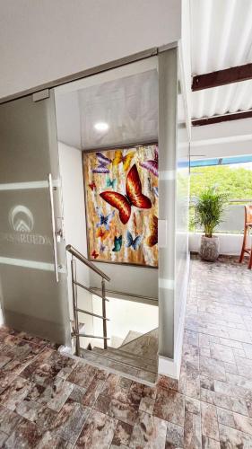 a painting on the wall of a room with a staircase at Hospedaje Casa Rueda in Barranquilla