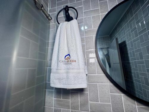 a bathroom with a towel hanging from a mirror at Hospedaje Casa Rueda in Barranquilla