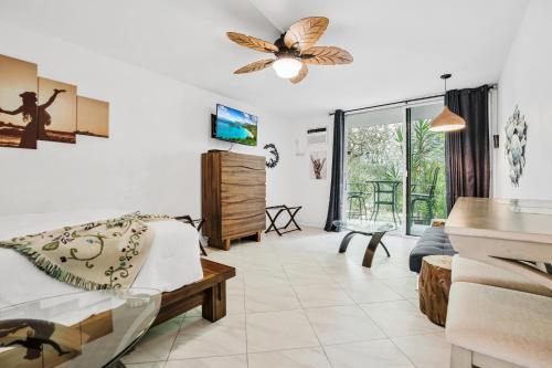 a living room with a bed and a couch at DOWNTOWN Hawaiian Theme Condo with Hot Tub, Pool & Beach - Kona Islander Inn in Kailua-Kona