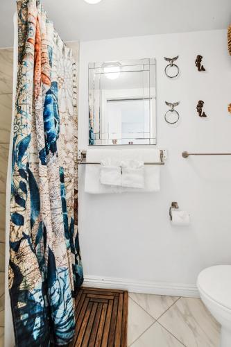 a bathroom with a tub and a sink and a mirror at DOWNTOWN Hawaiian Theme Condo with Hot Tub, Pool & Beach - Kona Islander Inn in Kailua-Kona