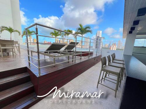 a balcony with chairs and a view of the ocean at Lindo flat no Manaíra Apart Hotel in João Pessoa
