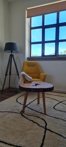 a living room with a chair and a coffee table at Montanha a Lápis in Proença-a-Nova
