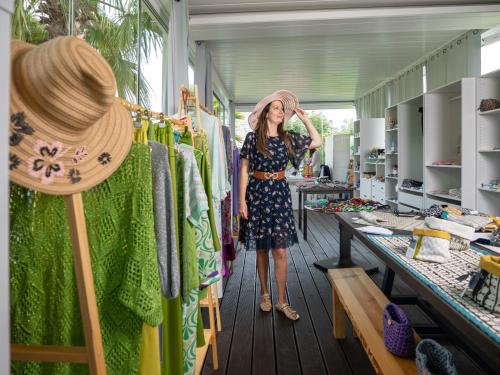 a woman is standing in a clothing store at Cala Sinzias Resort in Castiadas