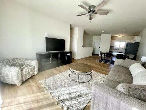 a living room with a couch and a table at Papillion The White Pine Modern Spacious with Garage in Papillion