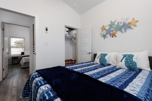 a bedroom with a bed with a blue and white comforter at The Blue Wahoo in Dauphin Island