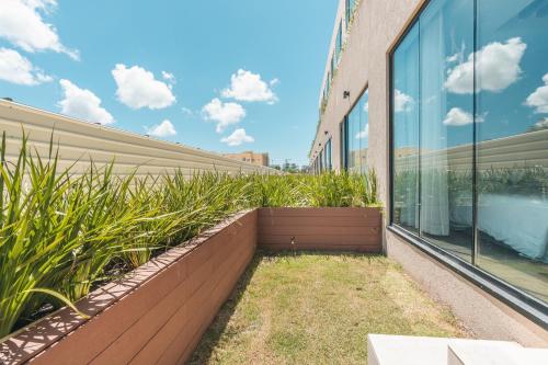a garden on the side of a building with plants at Probar Suites Punta Cana in Punta Cana