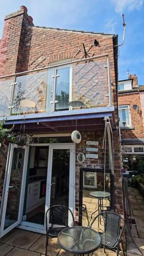 a brick building with a table and chairs on a patio at Redcar - Seafront, 6 Bedrooms, Short Stays in Redcar
