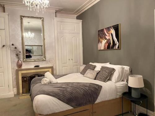 a bedroom with a large bed and a chandelier at Redcar - Seafront, 6 Bedrooms, Short Stays in Redcar