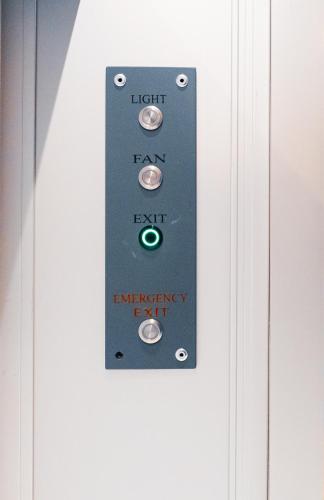 a lightswitch on a door with the words left and right emergency exit at Capsule Hotel Nyhavn63 in Copenhagen