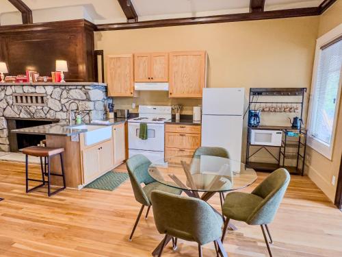 a kitchen with a table and chairs and a counter at Peach Street Inn by WanderLodges in Medford