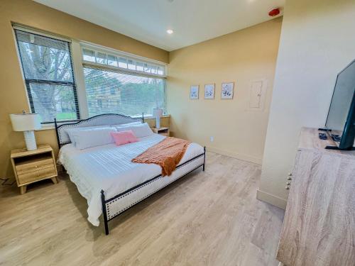a bedroom with a bed and a large window at Peach Street Inn by WanderLodges in Medford