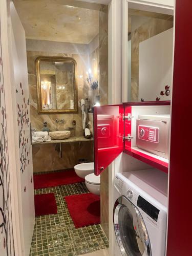 a bathroom with a toilet and a washer and dryer at Venice Luxury Watersdoor in Venice