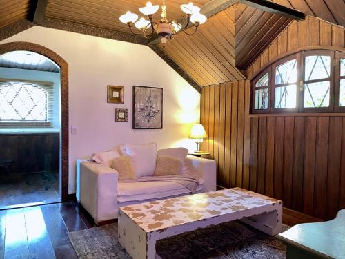 a living room with a couch and a table at Alma Hotel in Campos do Jordão