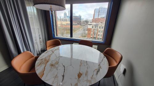 a table and chairs in a room with a large window at Holiday Inn Express & Suites - Charlotte - South End by IHG in Charlotte