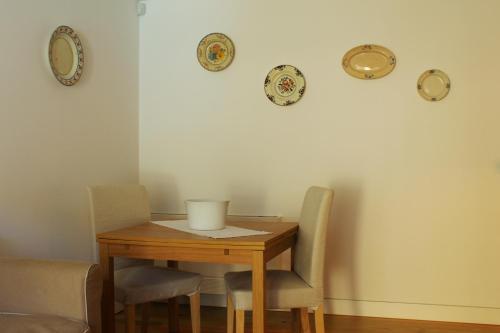 a dining room table with chairs and plates on the wall at Casa do Pomar - Eido do Pomar in Arcos de Valdevez