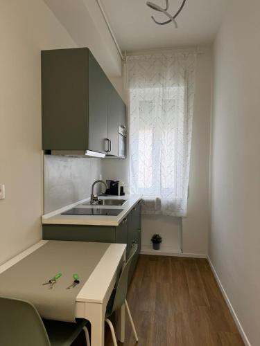 a small kitchen with a sink and a table at Dreaming Ortona in Ortona