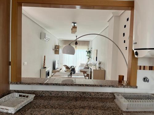 a large mirror in a living room with a dog in it at Duplex Torre la Sal Magic World La Tormesilla in La Estación