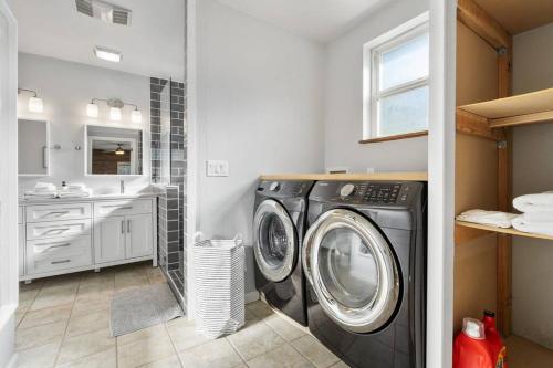 a laundry room with a washing machine and a sink at Peaceful Family Retreat Home w Firepit n Grill in Mountlake Terrace