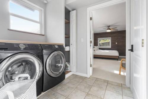 a washer and dryer in a room with a bedroom at Peaceful Family Retreat Home w Firepit n Grill in Mountlake Terrace