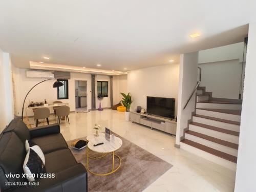 a living room with a couch and a table at BB Vila, Chokchai village9 in Nong Prue