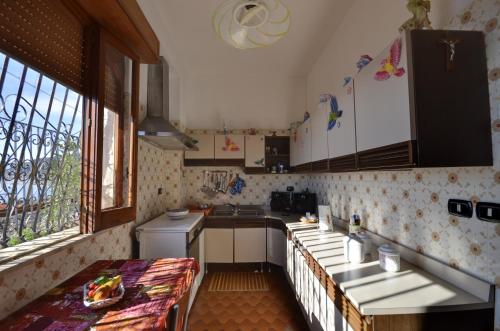 a kitchen with a counter and a table in it at Holiday Home Gionny & Mary in Taormina