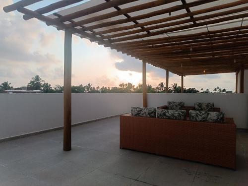 a couch sitting on top of a white wall at Flats Marina Maragogi in Maragogi