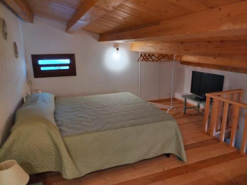 a bedroom with a bed and a flat screen tv at Cofano Bella Vista in Custonaci