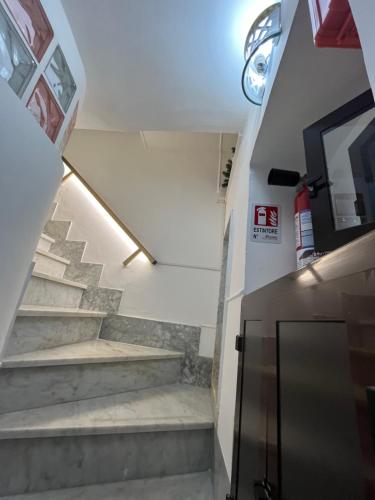 a stairway in a building with stairs and a door at B&B Due Su Due Holiday in Vietri sul Mare