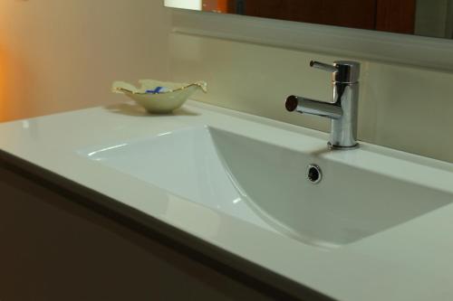 a bathroom sink with a bowl on top of it at Casa do Pomar - Eido do Pomar in Arcos de Valdevez