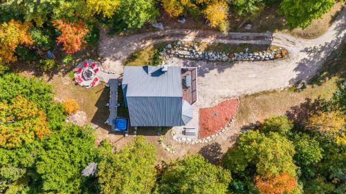 an aerial view of a house in the woods at Mitten Pines Cabin Hot Tub Fire Pit in Conway