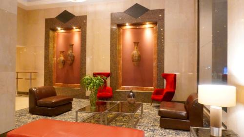 a lobby with a couch and chairs and a table at Bogota Plaza Hotel in Bogotá