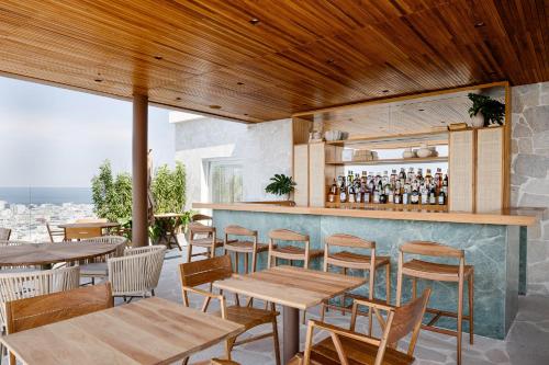 a restaurant with tables and chairs and a bar at Rio Othon Palace in Rio de Janeiro