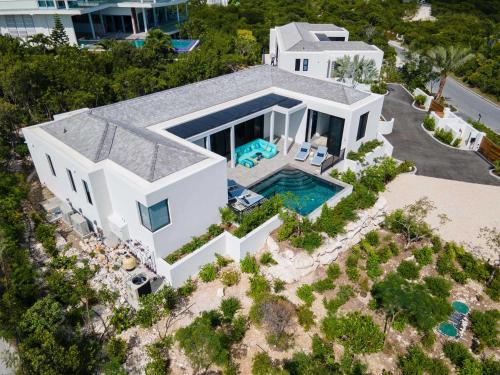 an aerial view of a house with a swimming pool at Villa Pluto 4 Bedroom with Private Pool Oceanfront in Providenciales