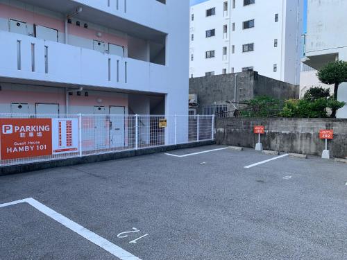 a parking lot next to a building with a fence at HAMBY101 in Chatan