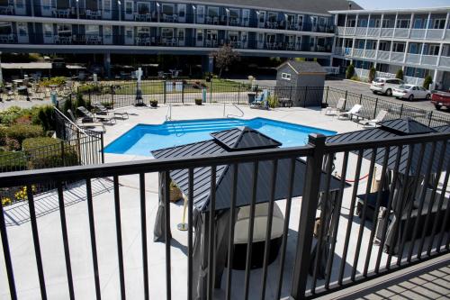a view of a pool from a balcony of a building at The Grand Beach Inn in Old Orchard Beach
