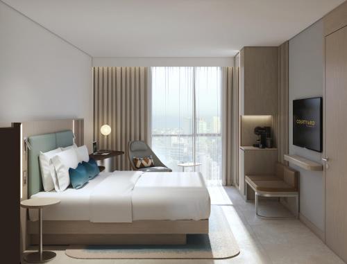 Ein Bett oder Betten in einem Zimmer der Unterkunft Courtyard by Marriott Dakar Diamniadio