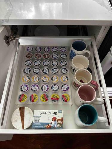 a drawer filled with donuts and cups of coffee at Charming Cape Cod Retreat in the Suburbs of NJ in Dumont