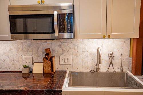 a kitchen counter with a sink and a microwave at Social Stays - Santa Barbara's FIRST hostel on State Street in Santa Barbara